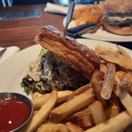 The Belmont signature dishes The Belmont Burger, Shrimp and Grits, Fried Chicken Sandwich, Truffle Fries